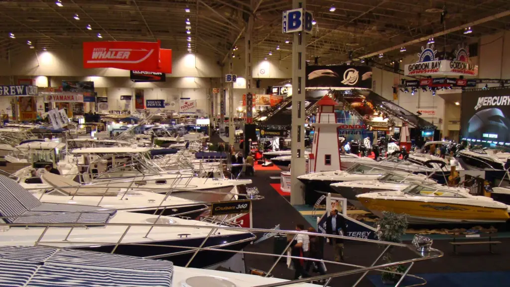 Boats displayed inside an expo hall.