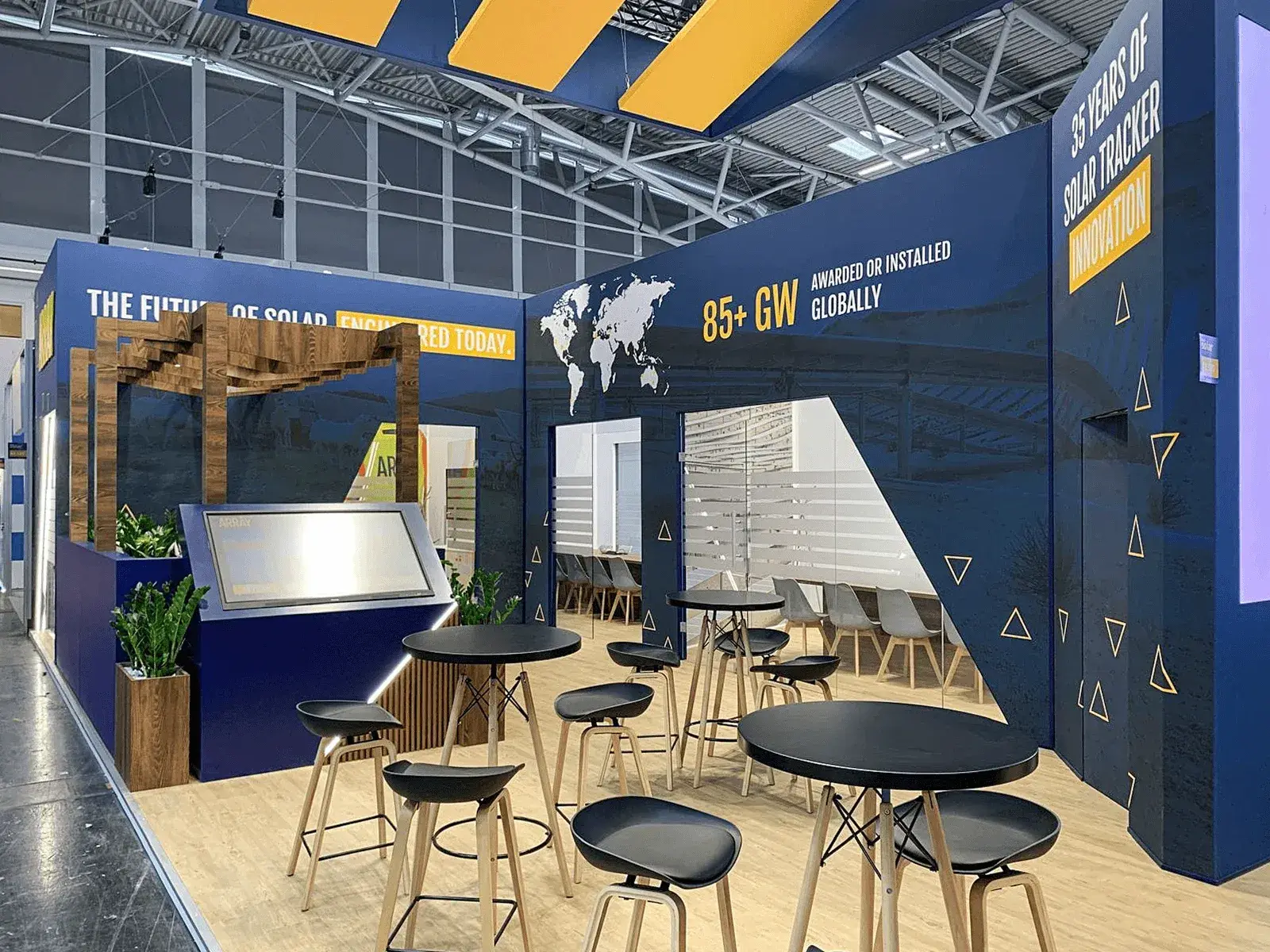 Custom-built Array exhibition stand with sculptural walls and integrated lighting