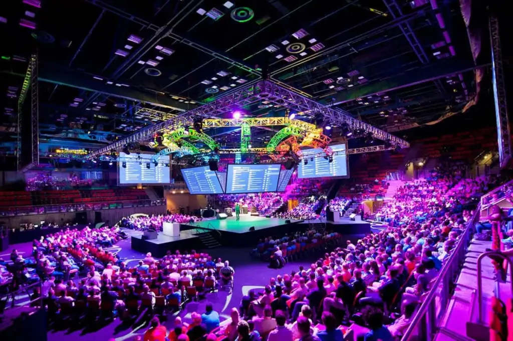 Durban ICC arena interior with packed audience and dramatic stage lighting at a major event