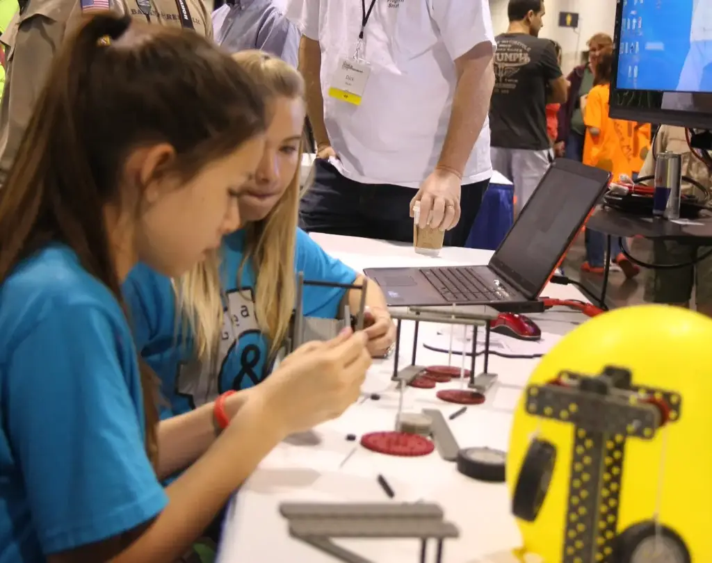 Two people testing out a product at an exhibition display.